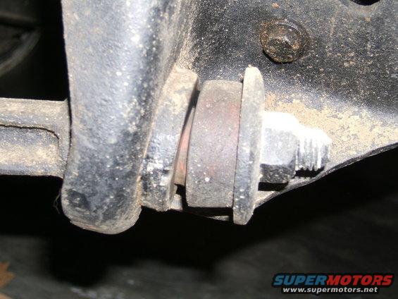 Close-up of a suspension bushing and bolt assembly