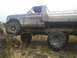 1978 Ford Bronco - This flatbed truck, likely from the mid-1970s, is navigating rough, rocky ground.