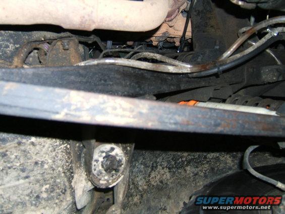 Undercarriage view showing suspension components and exhaust pipe