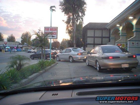 Cars waiting in line at a car wash entrance
