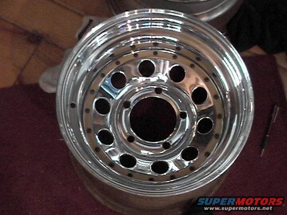 Chrome alloy wheel with multiple lug holes and a polished lip