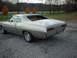 1971 Ford Torino - Silver 1971 Ford Torino coupe parked on gravel with trees in the background.