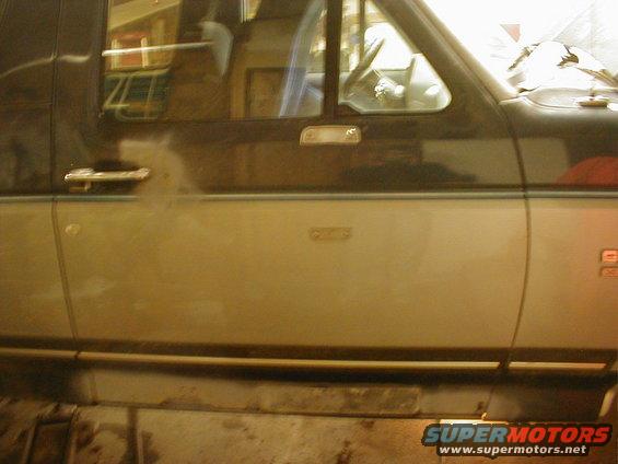 1987 Ford Bronco side door with chrome handle and two-tone paint