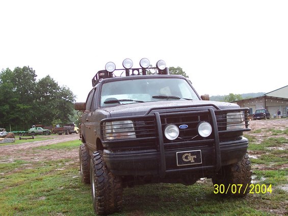 Modified Ford truck with bull bar, roof lights, and large tires. Date stamp reads 30/07/2004