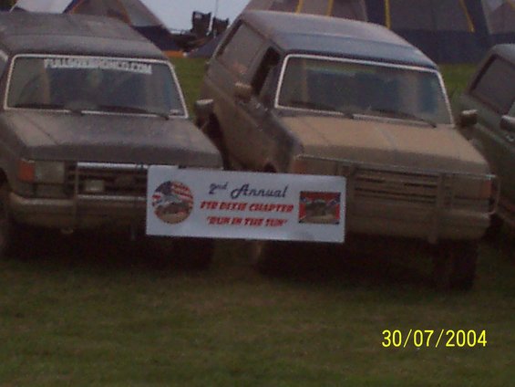 Gray Ford Bronco with a banner in front, seen from the front