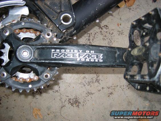 bicycle crankset with 'Race Face Prodigy DH Forged' logo and pedals