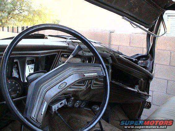1979 Ford Bronco interior with damaged dashboard and steering wheel
