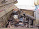 1973 Ford F-250 - The engine compartment of an older truck is visible, with various mechanical components and wiring.