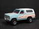 1979 Ford Bronco - A close-up of a toy Ford Bronco with distinctive racing stripes on its side.