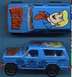 1979 Ford Bronco - A blue toy Bronco features Scooby-Doo graphics and 'SUPERMOTORS' branding on its side.