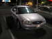 2002 Ford Taurus - A silver 2002 Ford Taurus is parked in a lot at night, with another vehicle visible to the right.
