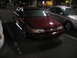 2002 Ford Taurus - Maroon Ford Taurus parked at night with another car beside it.