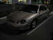2002 Ford Taurus - A tan sedan is parked in a lot at night, with another car visible in the background.