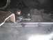 1991 Ford Bronco - A close-up view of the transmission shift linkage and pan of a vehicle.
