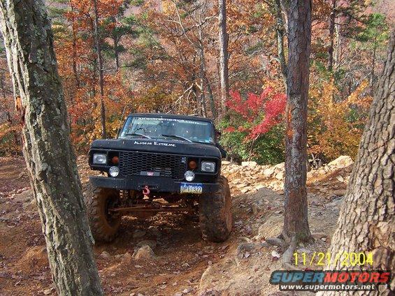 Black 1978 Ford Bronco on a rocky trail with fall foliage