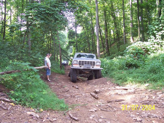 Gray 1979 Ford F-150 on a wooded trail, front view