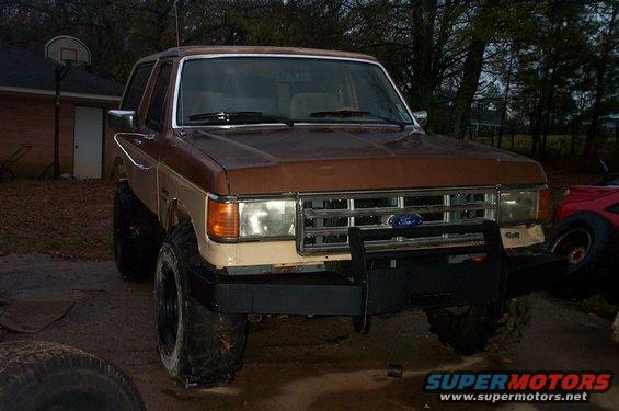 Brown and tan 1987 Ford Bronco front view with aftermarket bumper