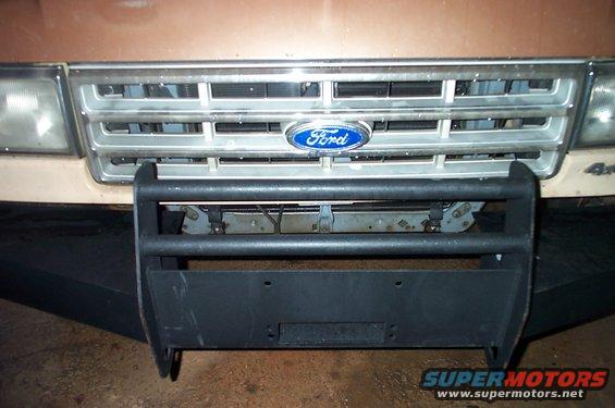 Ford grille and headlights with a black bull bar and winch plate attached to the front bumper
