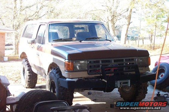 Brown and tan 1987 Ford Bronco with a winch on the front bumper