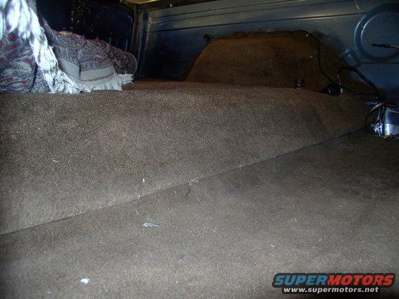 img_0028.jpg Under floor what ? I don't see any under floor storage opening, do you ? All there is here is a bone stock 86 rear floor and carpets.  Kidding aside, just lift the upper carpet flap and you have access to whatever you stored there, couldn't be easier or more concealed. 