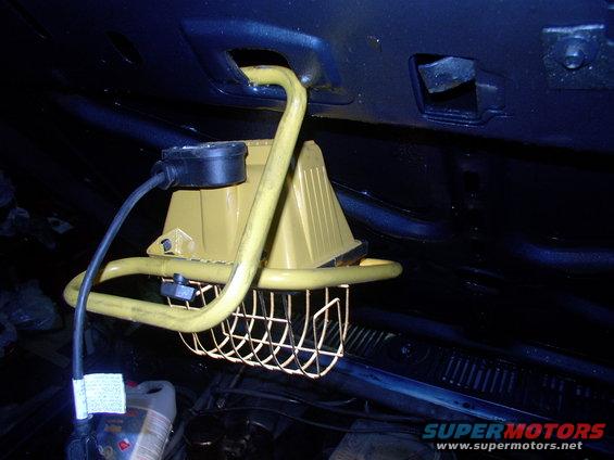 img_0174.jpg Perhaps the ultimate trouble light ! Noticed that the 500 watt flood hooked nicely into the hood hole near the latch catch.  Plenty of light now !