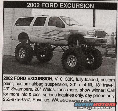 White lifted SUV with flame decals, large tires, and custom suspension, viewed from a 3/4 front angle