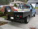 1968 Ford F-100 - This 1968 Ford F-100 pickup features a custom flatbed and a spare tire mounted on the side.