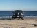 2004 Dodge 2500 - Front view of a 2004 Dodge 2500 on the beach, with a fishing rod nearby.