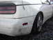 1988 Ford Crown Victoria - Rear quarter panel and bumper of a white Nissan 300ZX show significant damage and scuffing.