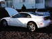 1988 Ford Crown Victoria - A white sports coupe with its hood open is parked on gravel, with another white vehicle behind it.
