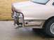 1999 Ford Crown Victoria - Rear view of a 1999 Ford Crown Victoria with significant damage to the bumper and quarter panel.