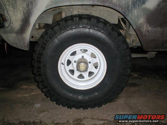 Close-up of a vehicle's front wheel and tire with a white rim