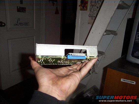 Electronic control unit with blue connector held in hand