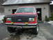 1990 Ford Bronco - This 1990 Ford Bronco is shown from the front, its iconic 4x4 badging and large tires.