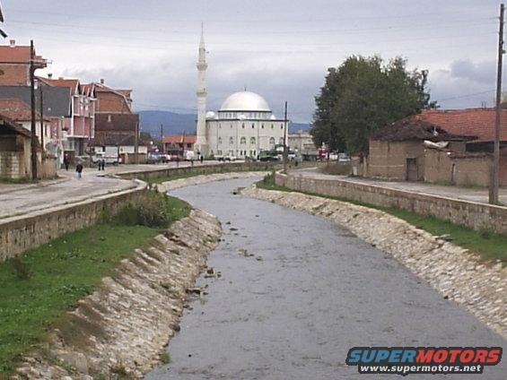 Same Vitina creek but two months later after a big rain. The creek is alot cleaner now that the water has risen and washed away the trash. Mosque in the background.