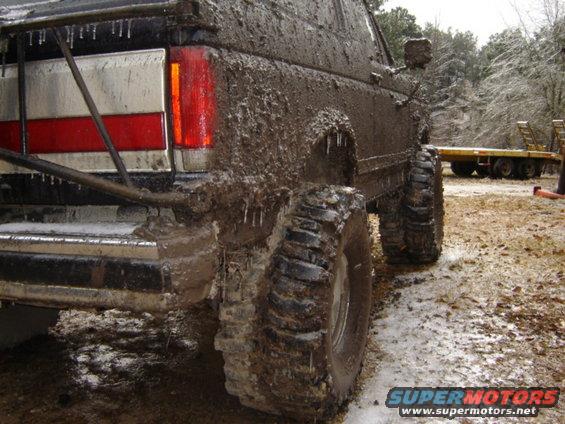 Mud-covered 1989 Ford Bronco rear quarter panel and tail light