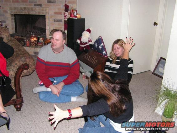 People sitting on the floor in a living room during a holiday gathering