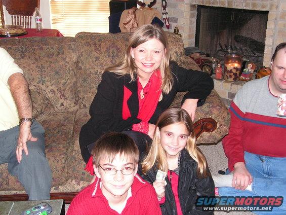 Family members sitting on a couch and floor in a living room
