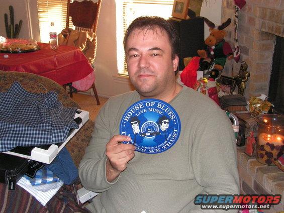 Man holding a blue 'House of Blues Live Music' sign