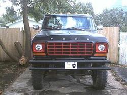 1978 Ford F-250 front view, black with red grille, aftermarket bumper, license plate visible