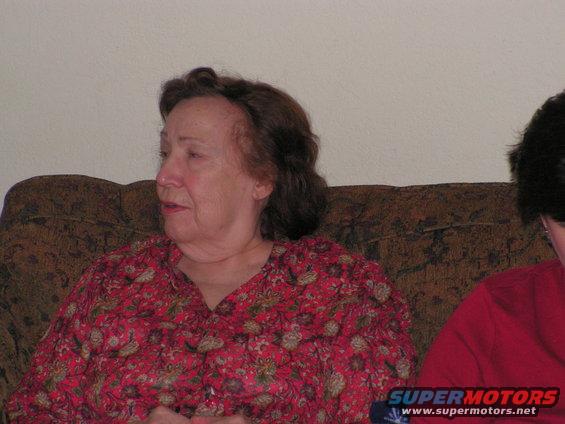 Woman in red floral shirt sitting on a couch