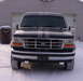 1993 Ford Bronco - This 1993 Ford Bronco is seen from the front in a snowy setting, racing stripes and a 5.0 badge.