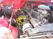 1989 Jeep YJ - Close-up view of the engine compartment in a red Jeep.