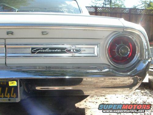 Rear of a 1964 Ford Galaxie XL showing taillight, chrome bumper, and 'Galaxie XL' badging