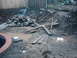 1978 Ford Bronco - A scene of construction debris, including lumber and rocks, scattered across a muddy area with several puddles.