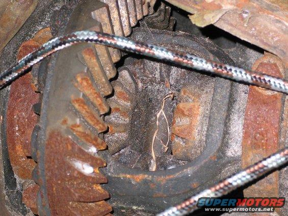 Close-up of rusty differential gears with a braided cable