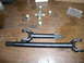 1978 Ford Bronco - Driveshaft components, including a universal joint and two shafts, are arranged on a wooden table.