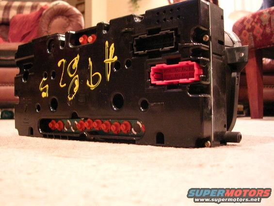Black electronic module with yellow writing 's.29.bt' and red connectors, viewed from the side
