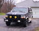1993 Ford Bronco - This Ford Bronco is parked in front of a garage with a basketball hoop mounted above it.