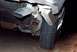 1985 Ford Crown Victoria LTD - Close-up view of the rear exhaust pipe and tire of a vehicle.